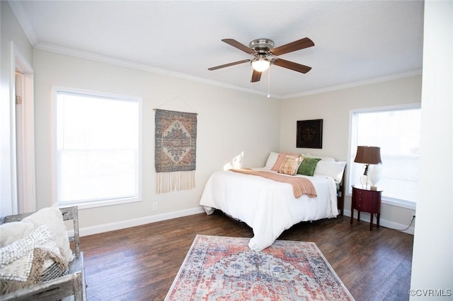 bedroom featuring dark hardwood / wood-style flooring, ceiling fan, and crown molding