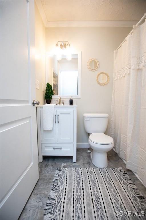 bathroom featuring vanity, toilet, and ornamental molding