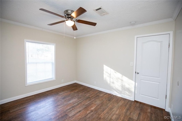 spare room with a textured ceiling, dark hardwood / wood-style flooring, ceiling fan, and crown molding