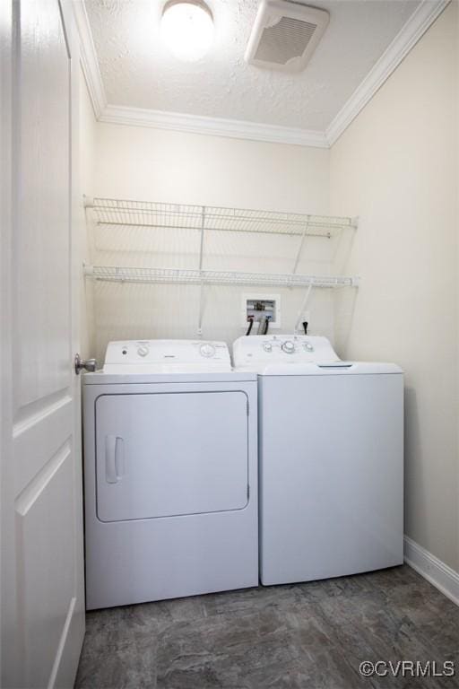 laundry room with a textured ceiling, crown molding, and washing machine and clothes dryer