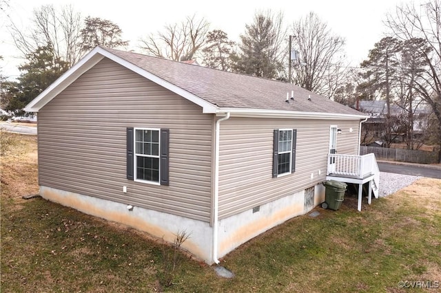 view of side of home with a lawn