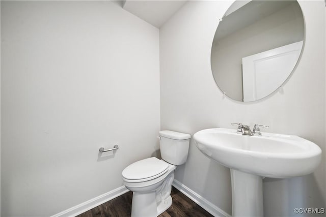 bathroom with sink, toilet, and hardwood / wood-style flooring