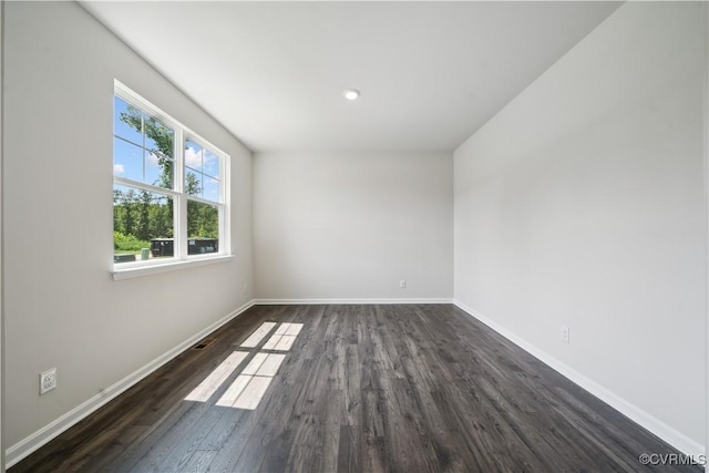 unfurnished room featuring dark wood-type flooring