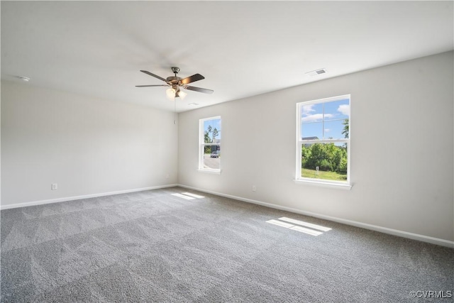 carpeted spare room featuring ceiling fan