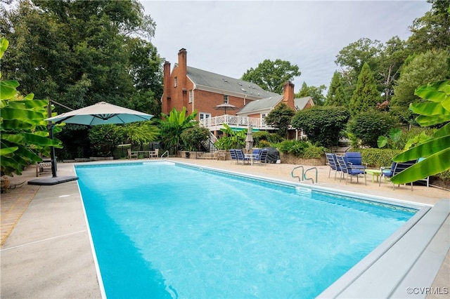 outdoor pool with a patio area