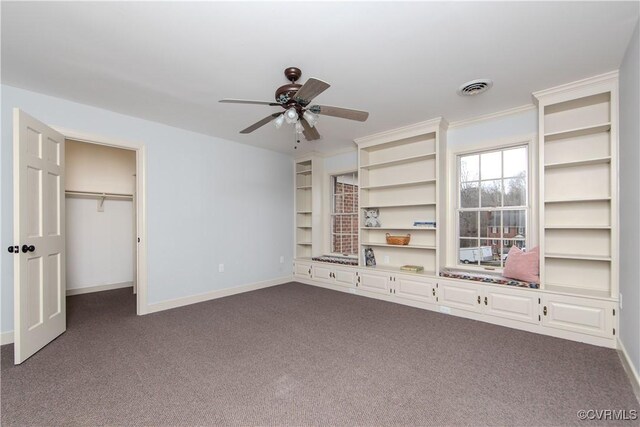 unfurnished bedroom with dark carpet, visible vents, and baseboards