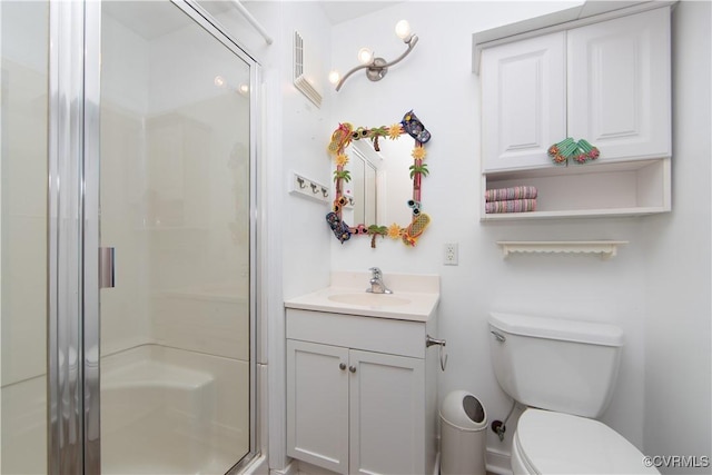 full bathroom with vanity, a shower stall, and toilet