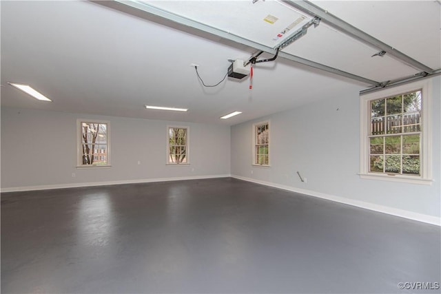 garage with a garage door opener and baseboards