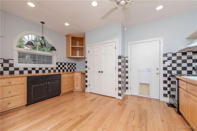 kitchen with pendant lighting, light countertops, light wood-style flooring, and stainless steel electric stove