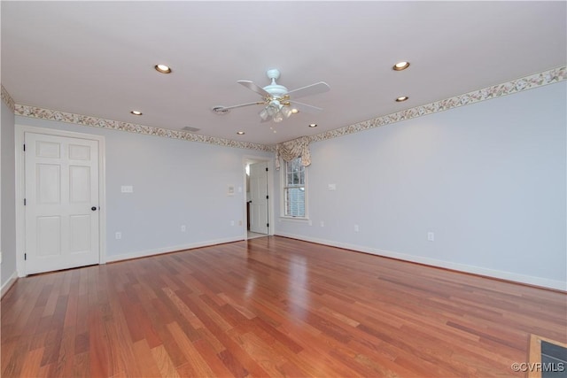 spare room with a ceiling fan, baseboards, wood finished floors, and recessed lighting