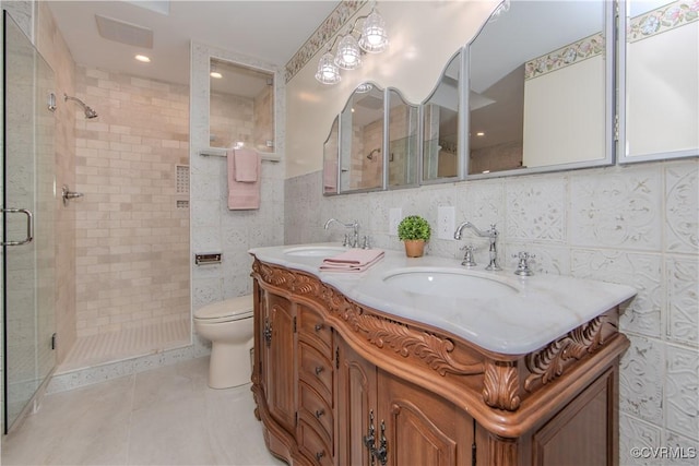 full bathroom with visible vents, a sink, tile walls, and toilet