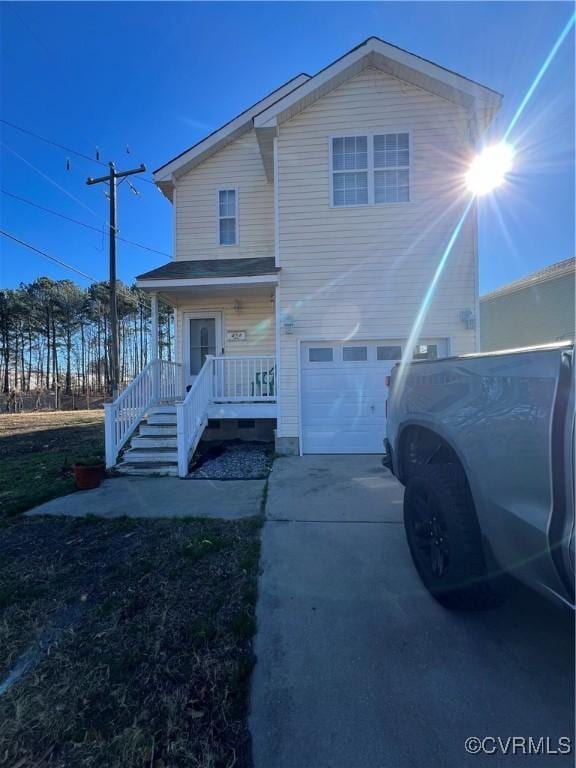 view of front facade featuring covered porch and a garage