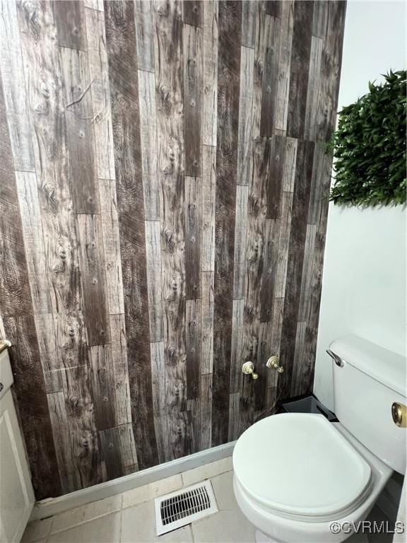 bathroom featuring tile patterned flooring, vanity, and toilet