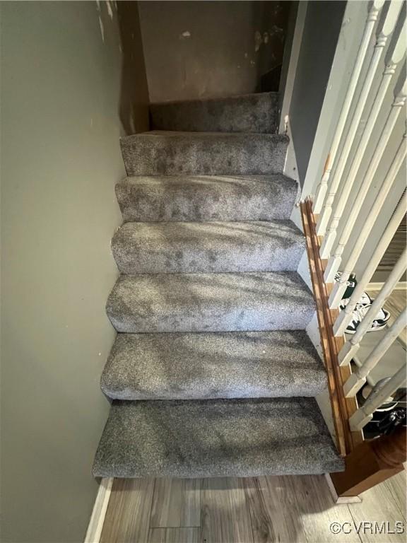 stairs featuring hardwood / wood-style flooring