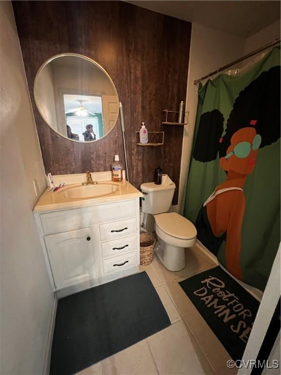 bathroom featuring a shower with curtain, vanity, tile patterned floors, and wood walls