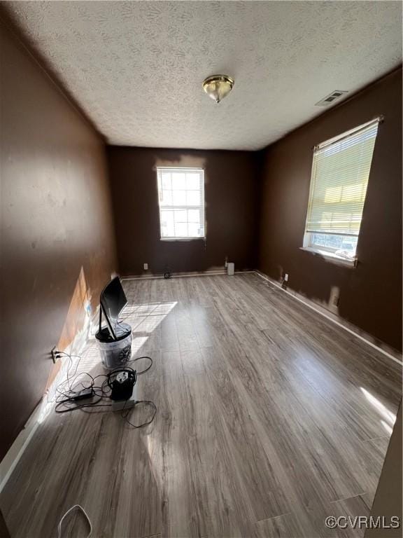 empty room featuring hardwood / wood-style floors and a textured ceiling