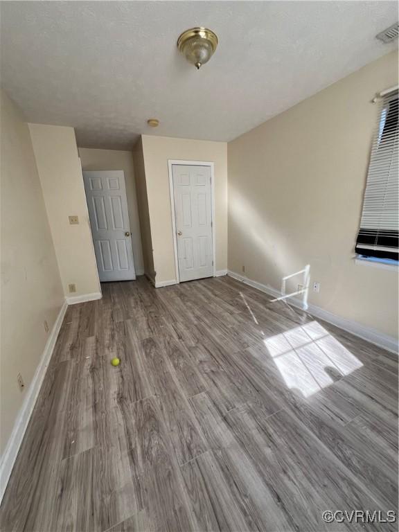 unfurnished bedroom with hardwood / wood-style floors