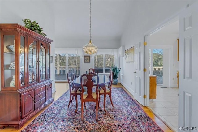 dining area with a notable chandelier and light hardwood / wood-style floors