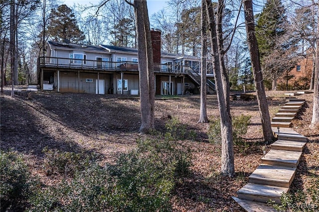 back of house featuring a wooden deck