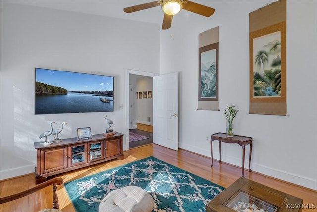 living room featuring hardwood / wood-style floors and ceiling fan