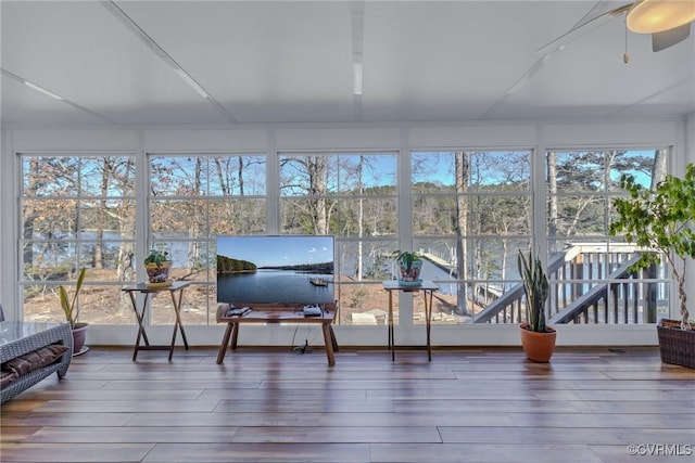 sunroom / solarium with plenty of natural light and ceiling fan