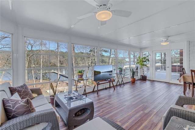 sunroom / solarium featuring plenty of natural light and ceiling fan