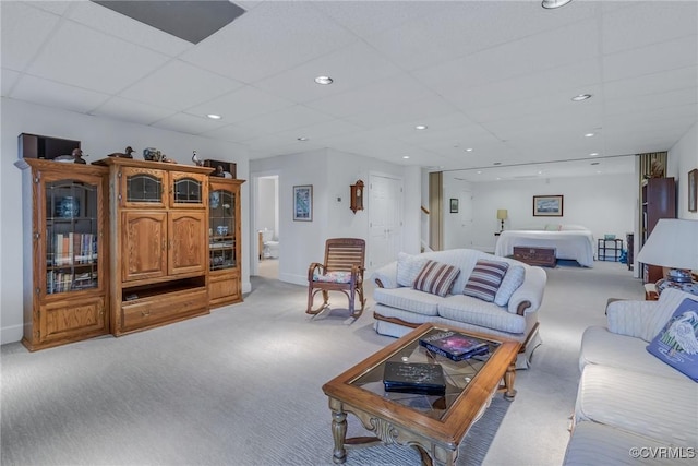 living room with light carpet and a drop ceiling