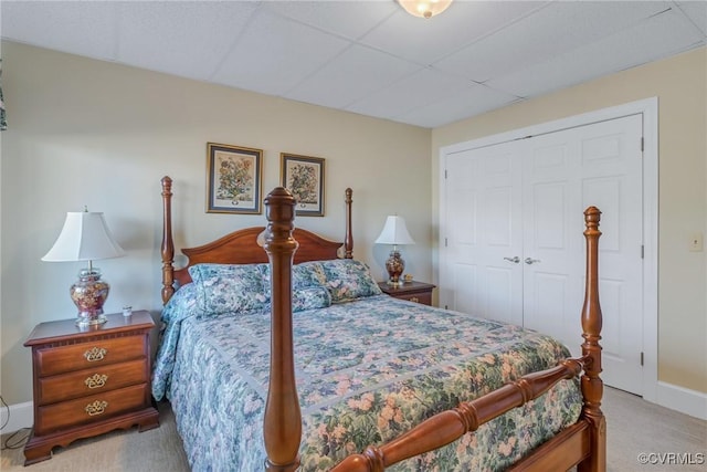 bedroom featuring light colored carpet and a closet