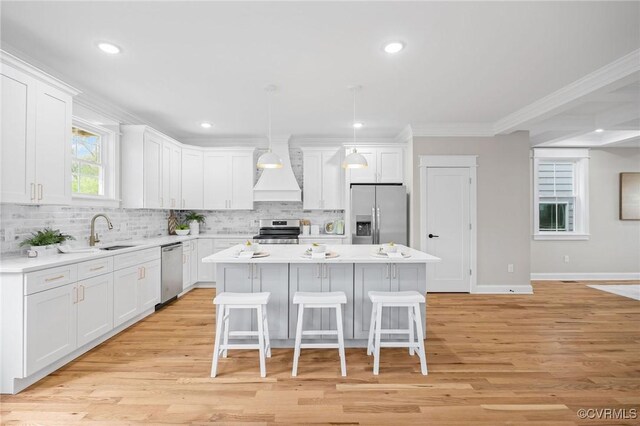 kitchen featuring appliances with stainless steel finishes, a kitchen island, and white cabinets