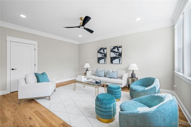 living room with ornamental molding, ceiling fan, and light hardwood / wood-style floors