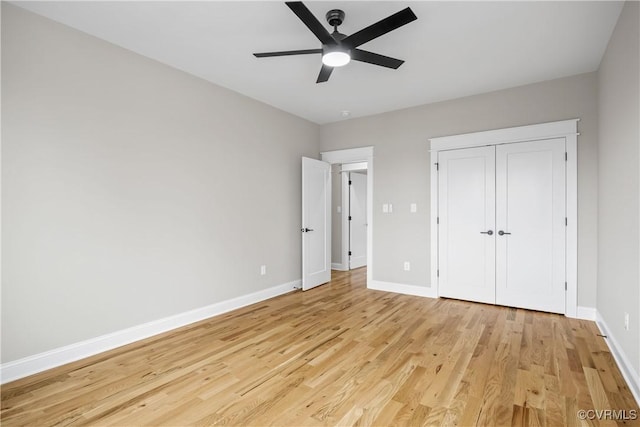 unfurnished bedroom with ceiling fan, a closet, and light wood-type flooring