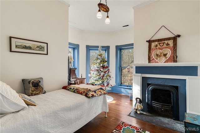 bedroom featuring dark hardwood / wood-style flooring and ornamental molding