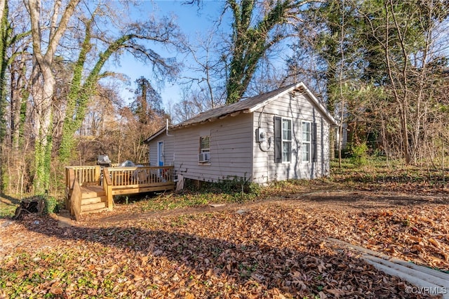 view of side of property featuring cooling unit and a deck