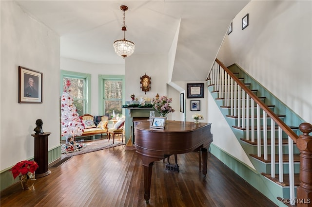 misc room with wood-type flooring and a notable chandelier