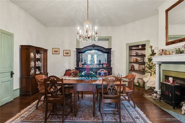 dining room with crown molding, dark hardwood / wood-style floors, and an inviting chandelier