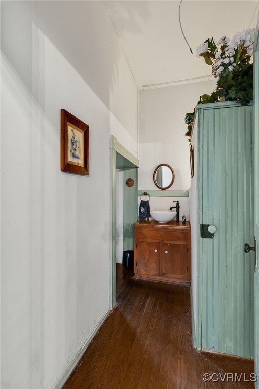 hall with dark hardwood / wood-style flooring and sink