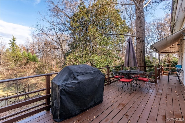 wooden terrace with a grill