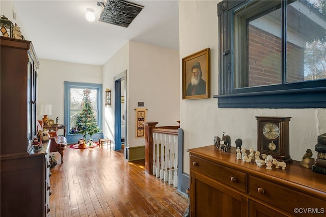 hall with hardwood / wood-style floors