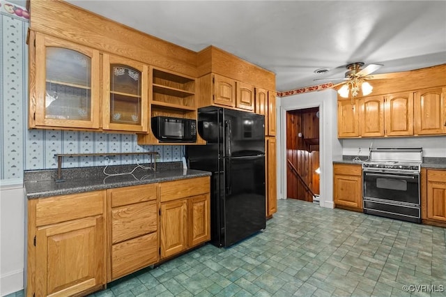 kitchen with black appliances, ceiling fan, and dark stone counters