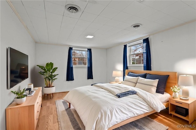 bedroom featuring light hardwood / wood-style floors and multiple windows