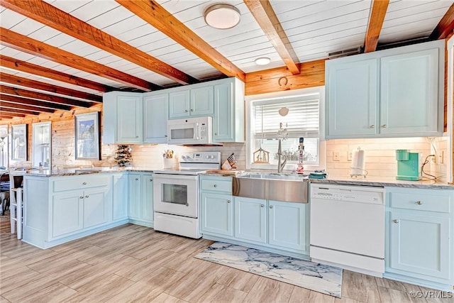 kitchen featuring beam ceiling, sink, light stone counters, light hardwood / wood-style flooring, and white appliances