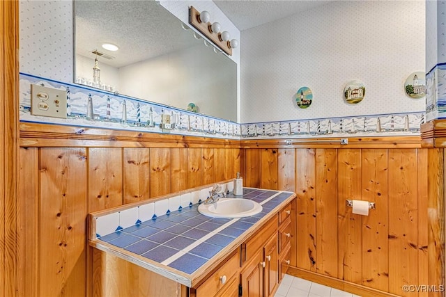 bathroom featuring vanity and a textured ceiling