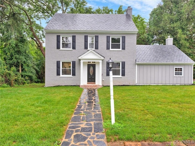 colonial home with a front lawn