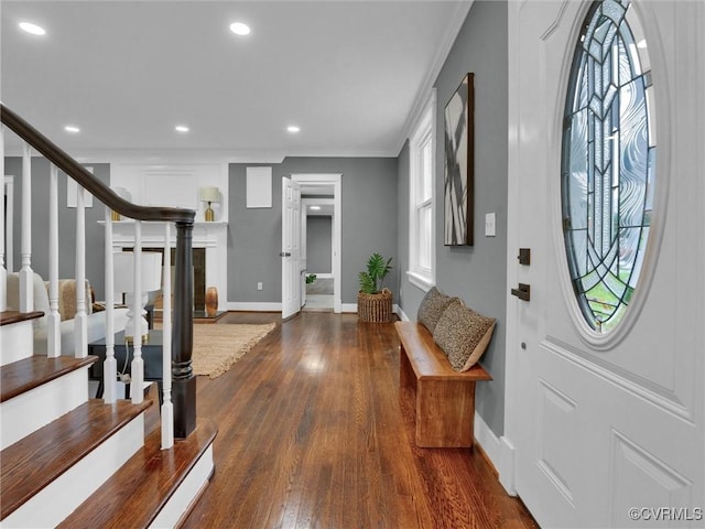 foyer entrance featuring dark hardwood / wood-style flooring and crown molding