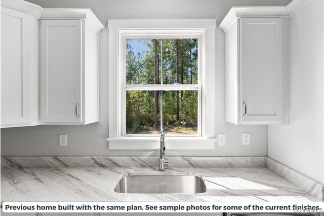 kitchen featuring sink and white cabinets