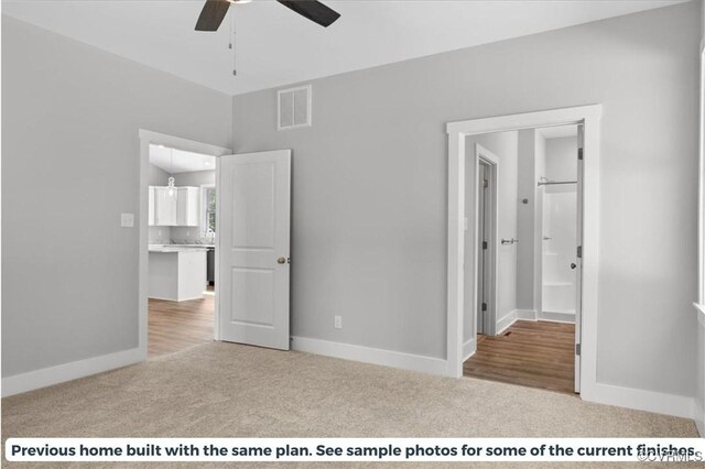 unfurnished bedroom with ensuite bath, ceiling fan, and light colored carpet