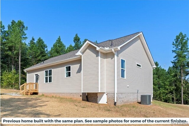 view of side of home featuring central AC