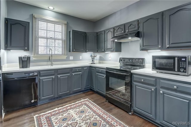 kitchen with dark hardwood / wood-style flooring, sink, gray cabinetry, and black appliances