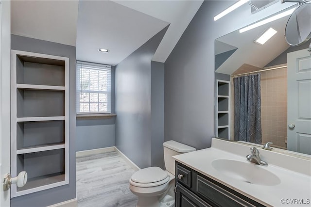 bathroom with vanity, lofted ceiling, a shower with curtain, hardwood / wood-style flooring, and toilet