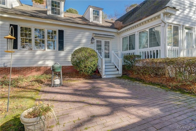 view of exterior entry featuring a patio